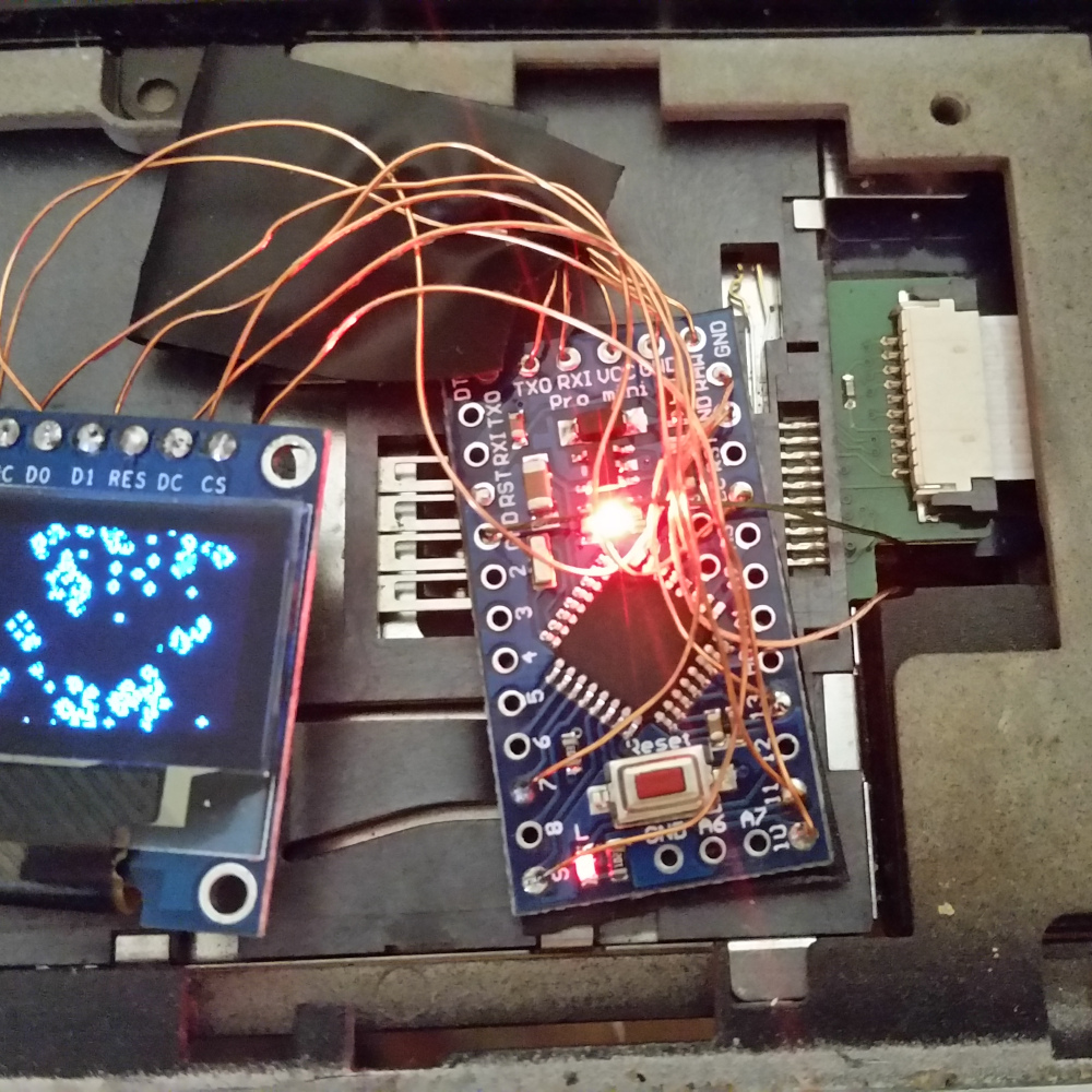 An OLED screen playing the game of life embedded in laptop