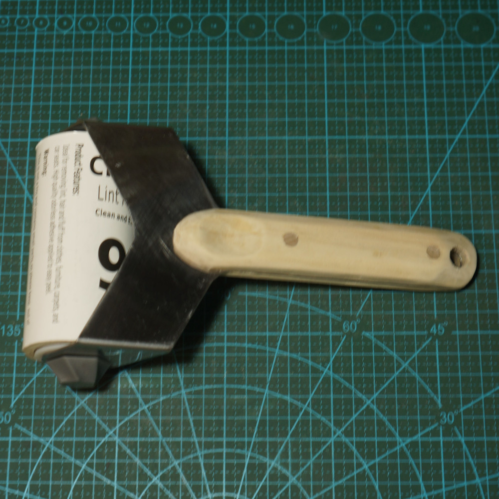 Polished steel and wood lint roller